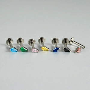Macro detail of G23 titanium labret studs showing internal thread and colorful zircon stones