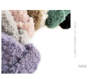 Detailed view of plush faux fur texture and diverse color palette of knitted hats