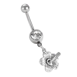 Macro view of silver stainless steel belly ring with flower pendant and clear zircon