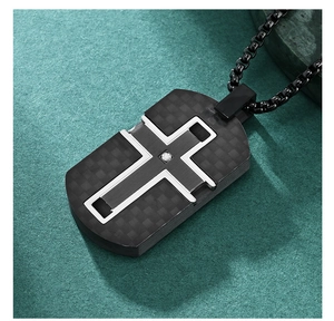 Macro detail of men's cross pendant with carbon fiber texture and sparkling center stone