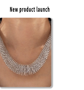 Detail of avant-garde silver punk necklace with sharp metallic spikes on model
