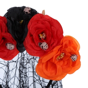 Detail of Halloween headband featuring realistic roses, mini skulls, and black lace veil
