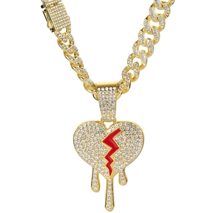 Gold plated iced out Cuban link chain with a sparkling red dripping broken heart pendant