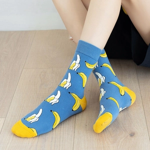 Detailed shot of blue cotton crew socks featuring bright yellow banana fruit patterns