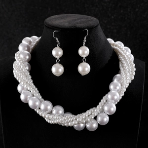 Multilayer pearl necklace and earrings set displayed on a professional black bust