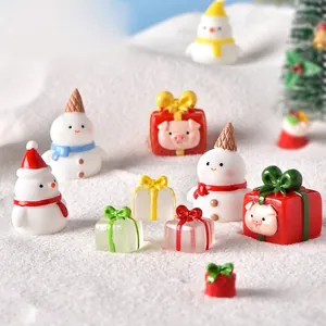 Christmas miniature figurines set featuring resin snowmen and gift boxes for snow globes