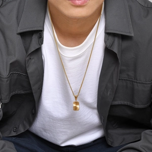 Men's gold titanium steel necklace featuring a rectangular pendant with sunburst texture