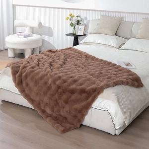 Detailed texture of thick brown plush blanket with 3D embossed bubble pattern design