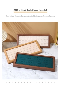 Macro view of walnut wood jewelry trays with plush velvet slots for rings and earrings