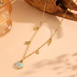 Detail of gold necklace featuring shell and conch pendants with blue gradient details