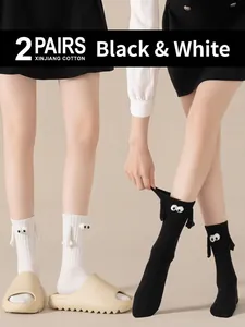 Cute magnetic hand-holding cartoon socks in black and white made of breathable Xinjiang cotton