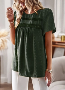 Detail of dark green blouse with lace stitching, pleated design and jacquard texture