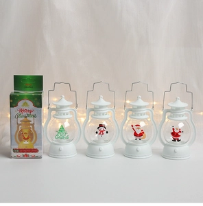Detail view of four white LED Christmas lanterns with festive Santa and snowman designs