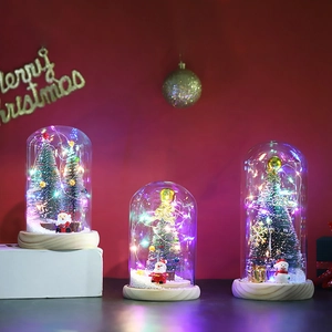 LED lighted Christmas tree in glass dome with miniature Santa and snowman on wood base