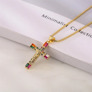 Detailed shot of gold box chain necklace with a colorful zircon inlaid cross pendant