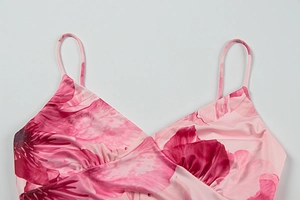 Detail of pink floral V-neck dress with slim spaghetti straps and floral pattern