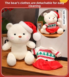 Detail of white Christmas teddy bear with removable red hat and festive knit sweater