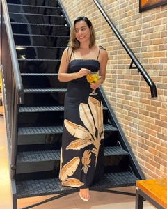 Detail of tropical leaf print on slim fit backless maxi dress with shoulder tie knots