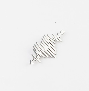 Macro shot of silver heartbeat waveform brooch with arrow details on white background