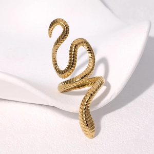Gold plated stainless steel snake shaped open ring on a white ceramic wave tray