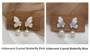 Detail of crystal butterfly earrings with faux pearls in pink and blue color variants