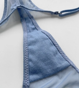Detail of light blue mesh thong showing fine stitching and silver metal buckle
