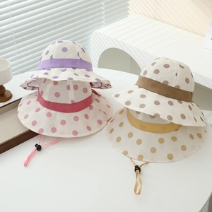 Detail of colorful polka dot sun hats for girls featuring adjustable chin straps