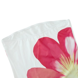 Detail of pink floral print on white strapless maxi dress with elastic neckline