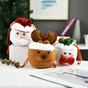 Detailed view of three 3D Christmas plush gift bags with Santa, Reindeer, and Snowman designs