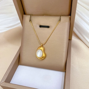 Minimalist gold titanium steel necklace with cat-eye stone pendant in a jewelry box