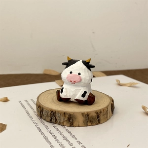 Macro detail of a hand-carved wooden cow figurine with fine textures on a wood base