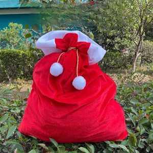 Detailed view of red Christmas drawstring backpack with plush white trim and gold cords