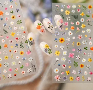 Macro view of Monet garden style wildflower nail art stickers with gold foil accents
