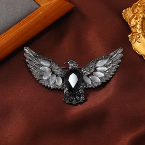 Vintage eagle brooch in silver alloy with black gemstone and white opal stones