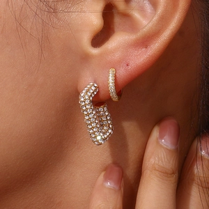 Dettaglio di orecchini a cerchio placcati oro 18K con micro-pave di zirconi su modella