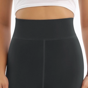 Detail of high-waisted thermal leggings with ribbed waistband and reinforced stitching