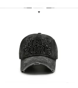 Detail of distressed New York patch embroidery on washed cotton baseball cap