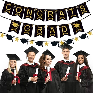 Detail of black and gold glitter Congrats Grad banner with star and cap hanging decorations