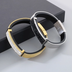 Macro shot of gold and silver mesh bracelets with crystal centerpiece on a jewelry box