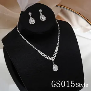 Detailed macro view of silver bridal jewelry set with sparkling teardrop crystal pendants