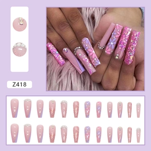 Detail of lavender press-on nails with floral art, sparkling sequins and 3D rhinestones