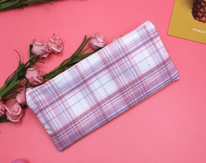 Detailed top view of a pink and blue checkered canvas pouch with white zipper closure