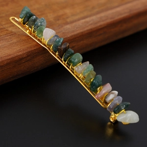 Close-up of colorful natural crystal stones wire-wrapped on a golden alloy hair pin