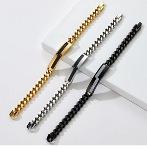 Detail of gold, silver and black Cuban link bracelets with carbon fiber inserts