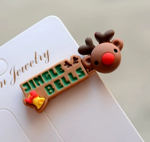 Close-up of reindeer Christmas hair clip with Jingle Bells text and 3D deer design