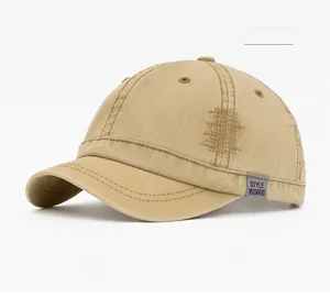Detail of camel washed baseball cap with distressed stitching and STYLE fabric label
