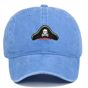Detail of vintage washed blue cotton baseball cap with pirate skull embroidery