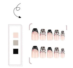 Detail of leopard print press-on nails with cat art and sparkling rhinestones decoration