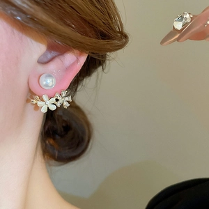 Detail of sweet floral pearl earrings with cat eye stone petals and sparkling zircon pavé