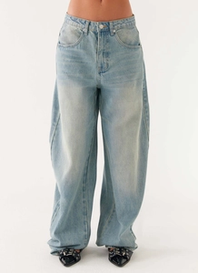 Front view of light blue wide-leg denim jeans with a vintage wash on a studio model